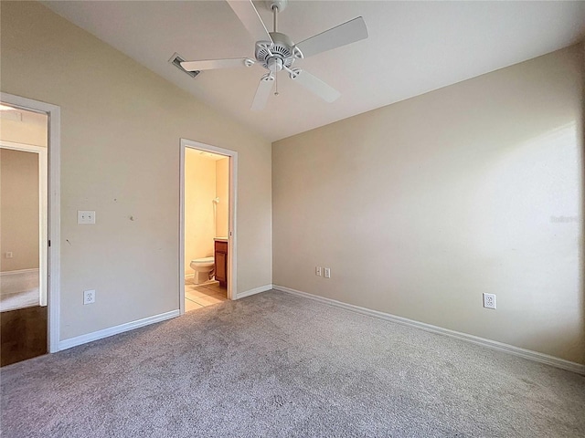 7504 Turtle View Dr, Ruskin, FL 33573 - unfurnished bedroom with vaulted ceiling, light colored carpet, ensuite bath, and a ceiling fan