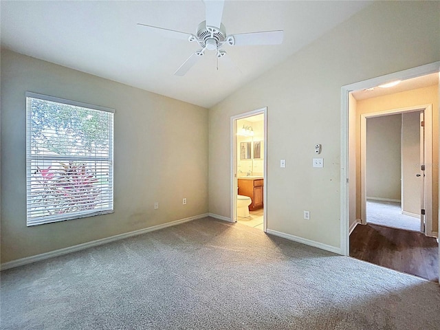 7504 Turtle View Dr, Ruskin, FL 33573 - unfurnished bedroom with light colored carpet, lofted ceiling, ensuite bathroom, and ceiling fan