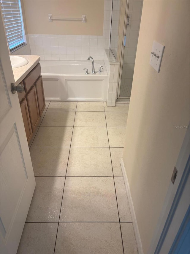 7504 Turtle View Dr, Ruskin, FL 33573 - bathroom featuring tile patterned flooring, vanity, a garden tub, and a shower stall