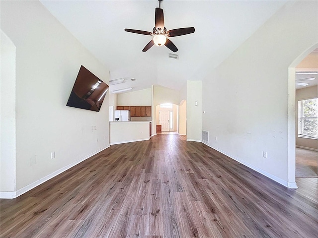 7504 Turtle View Dr, Ruskin, FL 33573 - unfurnished living room with arched walkways, ceiling fan, dark wood finished floors, and vaulted ceiling
