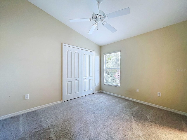 7504 Turtle View Dr, Ruskin, FL 33573 - unfurnished bedroom featuring carpet flooring, lofted ceiling, a closet, and a ceiling fan