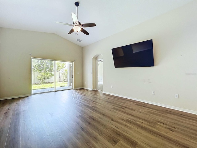 7504 Turtle View Dr, Ruskin, FL 33573 - empty room with arched walkways, ceiling fan, wood finished floors, and vaulted ceiling