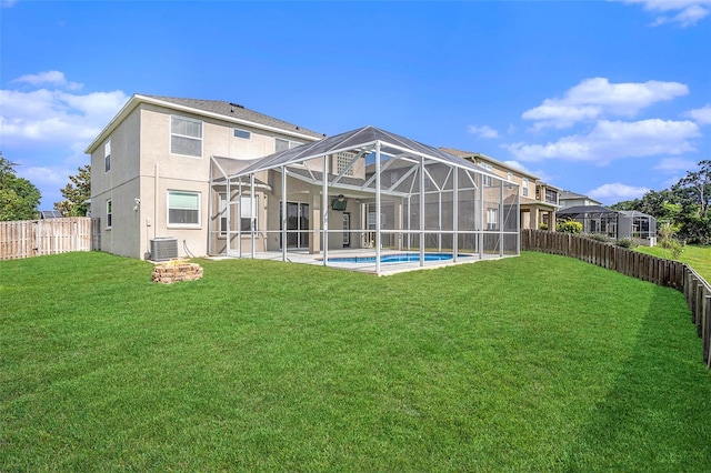5804 Butterfield St, Riverview, FL 33578 - back of house featuring central air condition unit, stucco siding, a patio area, and glass enclosure