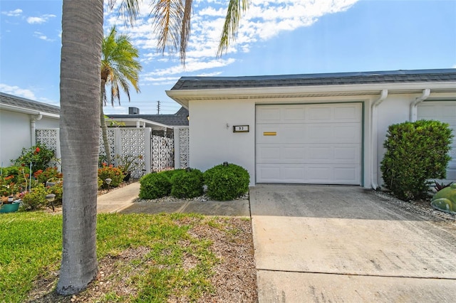 garage with concrete driveway