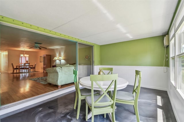 dining area featuring wainscoting and a chandelier