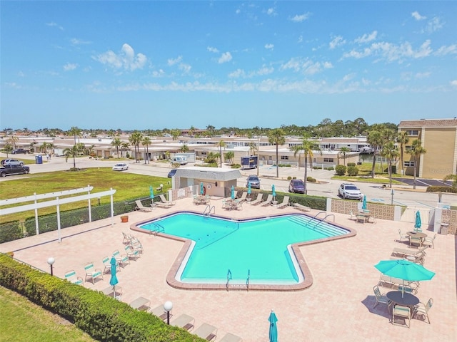 community pool featuring a patio and fence