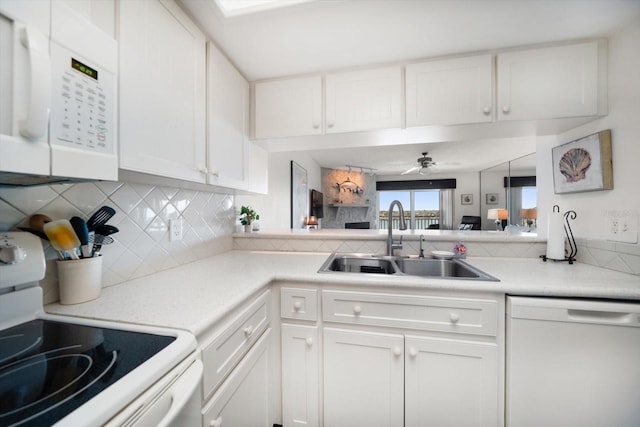 kitchen featuring a sink, white appliances, decorative backsplash, and white cabinets