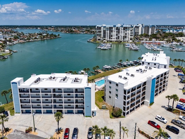 birds eye view of property with a water view and a view of city
