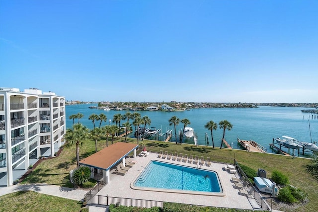 community pool featuring a water view and a patio