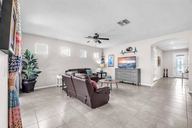 11606 Kilkenny Coral Dr, Riverview, FL 33579 - living room featuring arched walkways, ceiling fan, light tile patterned floors, and baseboards