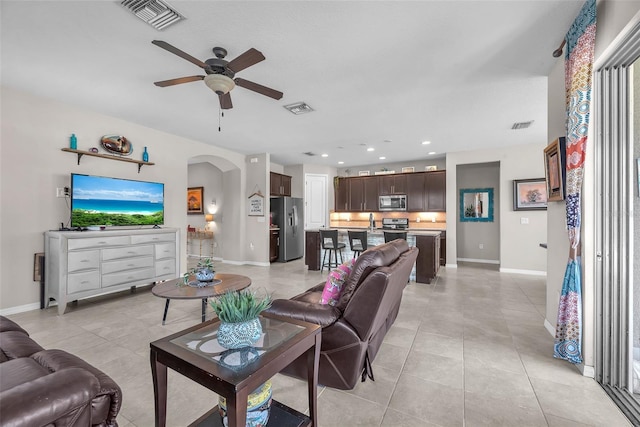 11606 Kilkenny Coral Dr, Riverview, FL 33579 - living area featuring arched walkways, baseboards, ceiling fan, light tile patterned flooring, and recessed lighting