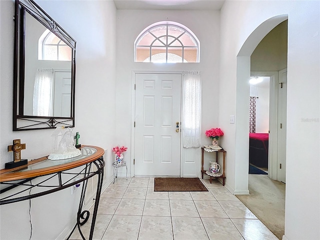 24305 Denali Ct, Lutz, FL 33559 - foyer featuring arched walkways, light tile patterned flooring, and a towering ceiling