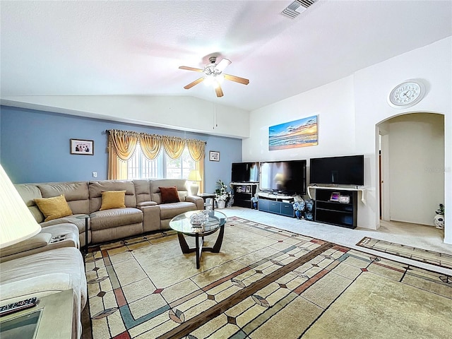 24305 Denali Ct, Lutz, FL 33559 - carpeted living room with lofted ceiling, arched walkways, and ceiling fan