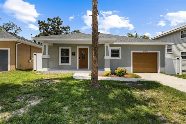 2906 E Columbus Dr, Tampa, FL 33605 - view of front of home with concrete driveway, a garage, stucco siding, and a front yard