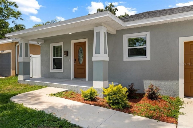 2906 E Columbus Dr, Tampa, FL 33605 - entrance to property featuring covered porch, stucco siding, and a garage