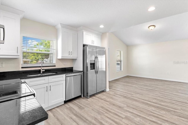 2906 E Columbus Dr, Tampa, FL 33605 - kitchen with a wealth of natural light, light wood-style flooring, appliances with stainless steel finishes, and a sink