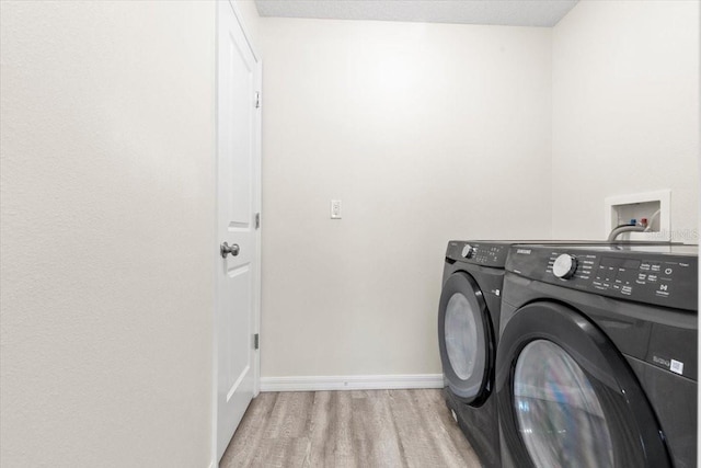 2906 E Columbus Dr, Tampa, FL 33605 - washroom with washing machine and clothes dryer, baseboards, laundry area, and wood finished floors