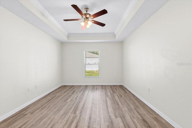2906 E Columbus Dr, Tampa, FL 33605 - empty room featuring wood finished floors, ornamental molding, a ceiling fan, a tray ceiling, and baseboards
