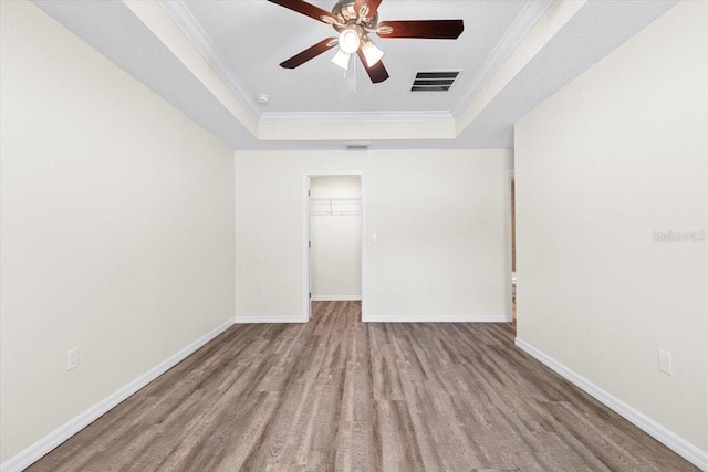 2906 E Columbus Dr, Tampa, FL 33605 - spare room with wood finished floors, a ceiling fan, visible vents, baseboards, and a raised ceiling