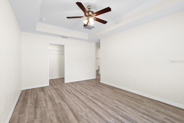 2906 E Columbus Dr, Tampa, FL 33605 - unfurnished bedroom featuring a tray ceiling, visible vents, wood finished floors, and ornamental molding