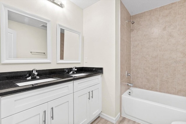 2906 E Columbus Dr, Tampa, FL 33605 - bathroom featuring a sink, double vanity, and shower / washtub combination