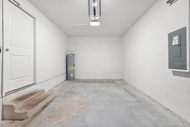 2906 E Columbus Dr, Tampa, FL 33605 - garage featuring concrete block wall, water heater, and electric panel