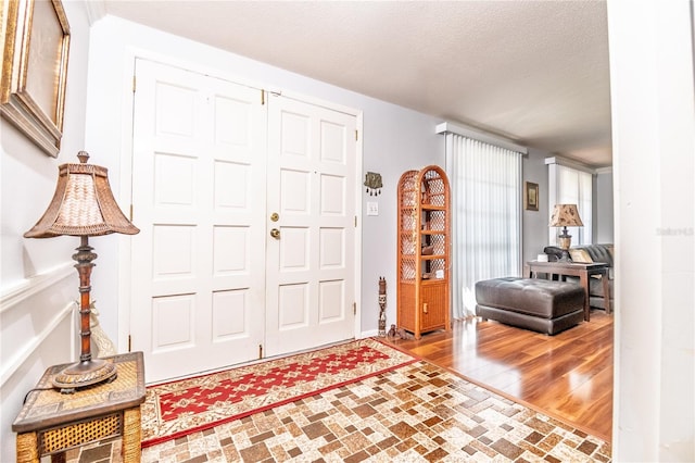 12303 Fieldstone Ln, Hudson, FL 34667 - entrance foyer with a textured ceiling and wood finished floors