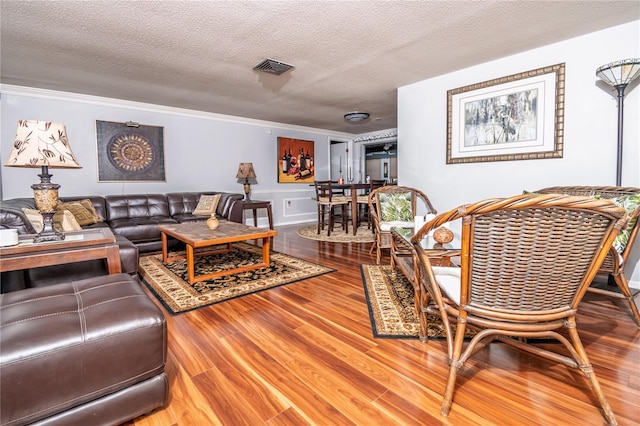12303 Fieldstone Ln, Hudson, FL 34667 - living area featuring ornamental molding, a textured ceiling, and wood finished floors