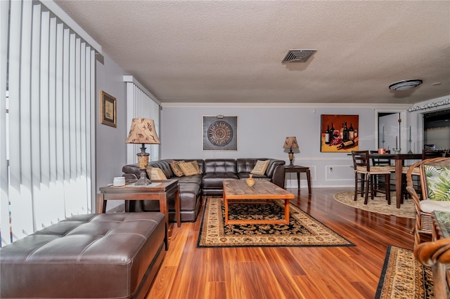 12303 Fieldstone Ln, Hudson, FL 34667 - living room with a textured ceiling, wood finished floors, and crown molding