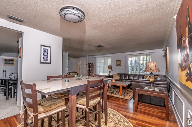 12303 Fieldstone Ln, Hudson, FL 34667 - dining area featuring a textured ceiling and wood finished floors