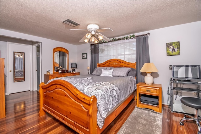 12303 Fieldstone Ln, Hudson, FL 34667 - bedroom with wood finished floors, a textured ceiling, and ceiling fan