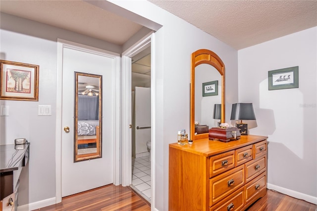 12303 Fieldstone Ln, Hudson, FL 34667 - hall with dark wood-style flooring, a textured ceiling, and baseboards