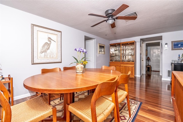 12303 Fieldstone Ln, Hudson, FL 34667 - dining space featuring wood finished floors, ceiling fan, a textured ceiling, and baseboards