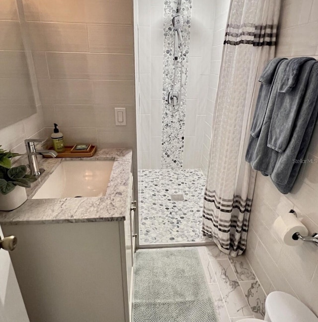 323 Rex Pl Unit G, Madeira Beach, FL 33708 - full bathroom with tile walls, a stall shower, and vanity