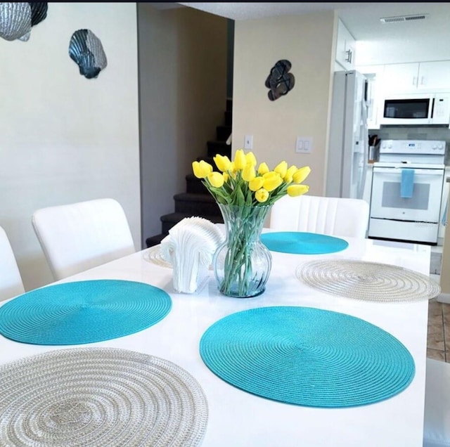 323 Rex Pl Unit G, Madeira Beach, FL 33708 - dining room featuring stairway