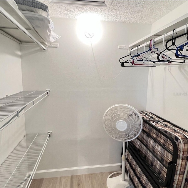 323 Rex Pl Unit G, Madeira Beach, FL 33708 - walk in closet featuring wood finished floors