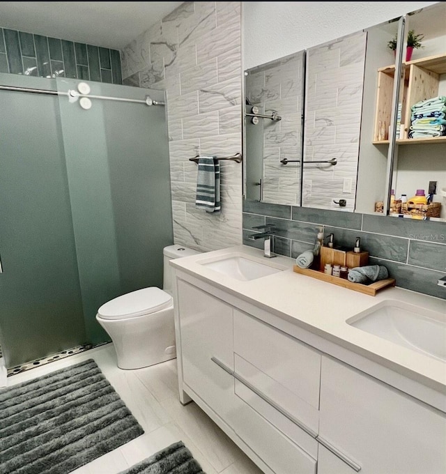 323 Rex Pl Unit G, Madeira Beach, FL 33708 - full bathroom with double vanity, tile walls, a stall shower, and tasteful backsplash