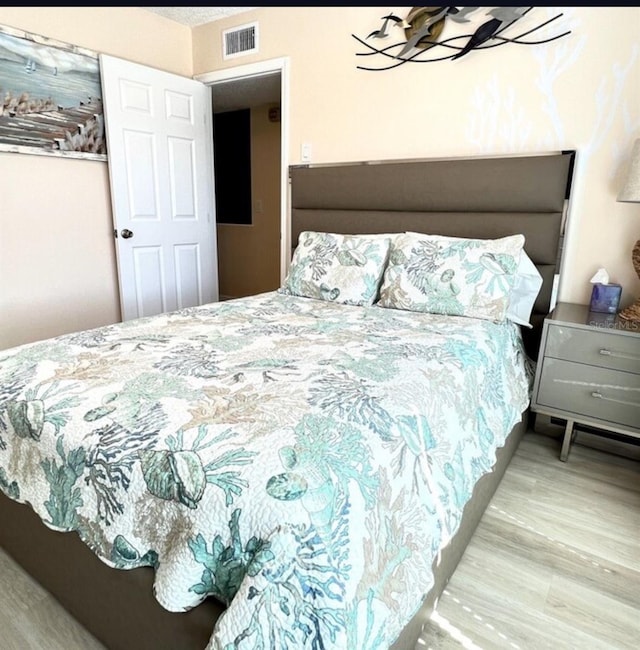 323 Rex Pl Unit G, Madeira Beach, FL 33708 - bedroom featuring wood finished floors