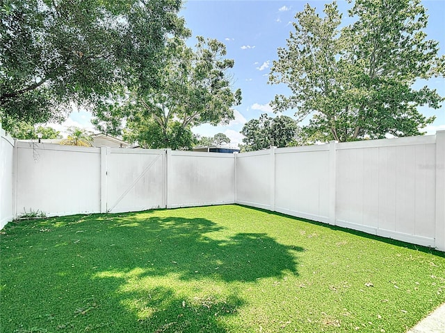 view of yard with a fenced backyard