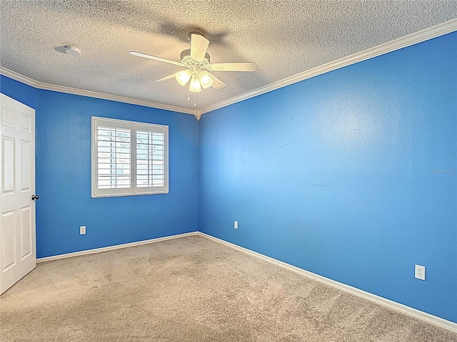 carpeted spare room featuring crown molding, a textured ceiling, baseboards, and ceiling fan