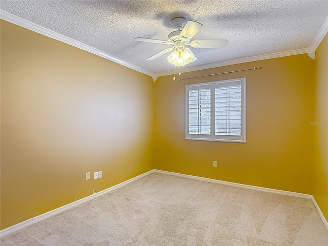 empty room with a ceiling fan, a textured ceiling, baseboards, crown molding, and carpet floors