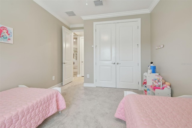 bedroom featuring ornamental molding, carpet flooring, a closet, and baseboards