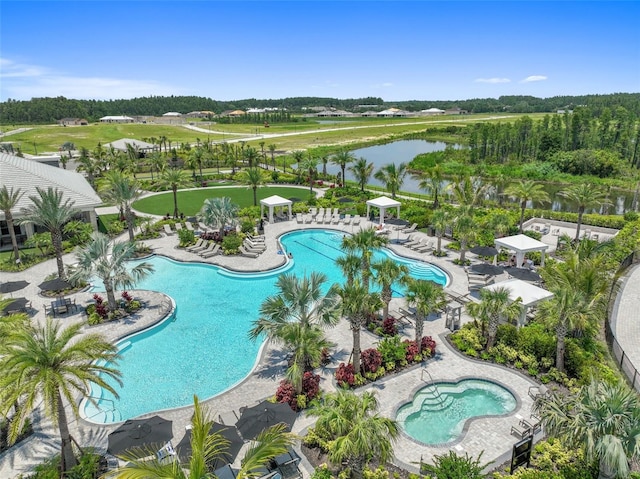 community pool featuring a water view and a patio
