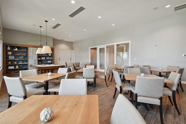 dining area with recessed lighting and wood finished floors
