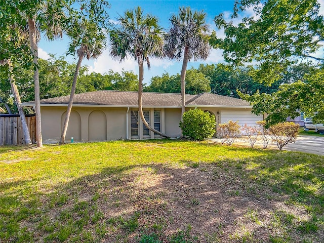 9679 W Pimpernel Ln, Crystal River, FL 34429 - single story home with roof with shingles, fence, a garage, stucco siding, and a front lawn
