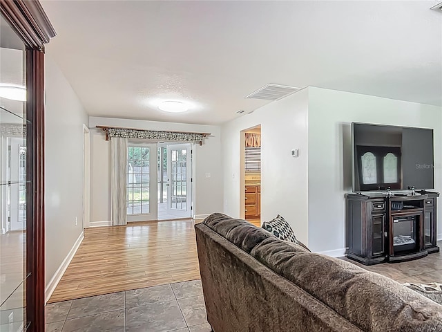 9679 W Pimpernel Ln, Crystal River, FL 34429 - tiled living room featuring baseboards and visible vents