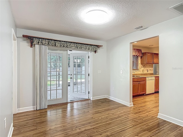 9679 W Pimpernel Ln, Crystal River, FL 34429 - interior space with a textured ceiling, baseboards, and light wood-style floors