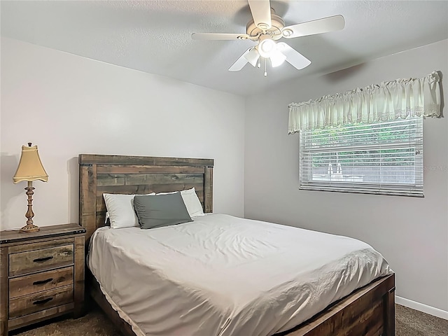 9679 W Pimpernel Ln, Crystal River, FL 34429 - bedroom with a ceiling fan, dark carpet, and baseboards