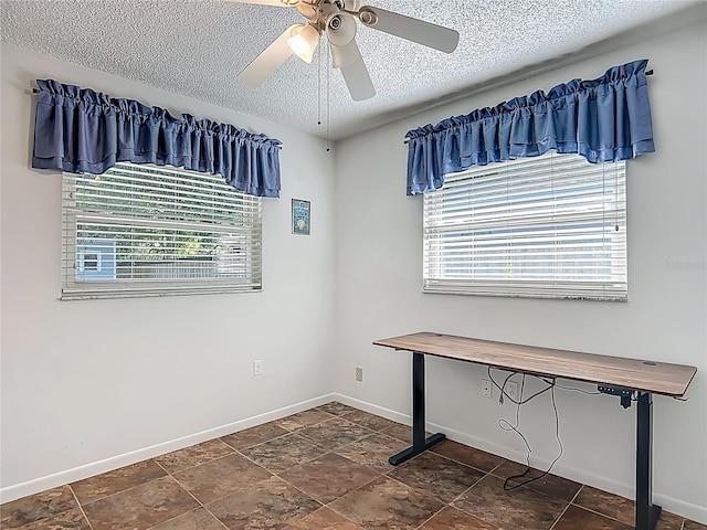9679 W Pimpernel Ln, Crystal River, FL 34429 - interior space featuring a textured ceiling, baseboards, a ceiling fan, and stone finish flooring