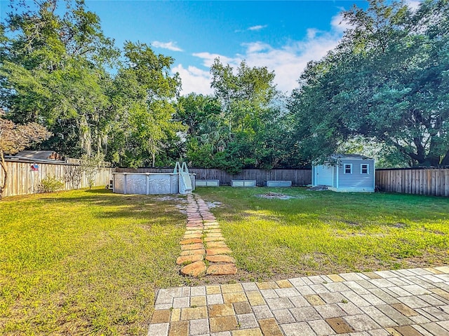9679 W Pimpernel Ln, Crystal River, FL 34429 - view of yard featuring a fenced backyard, an outdoor structure, a fenced in pool, and a storage shed